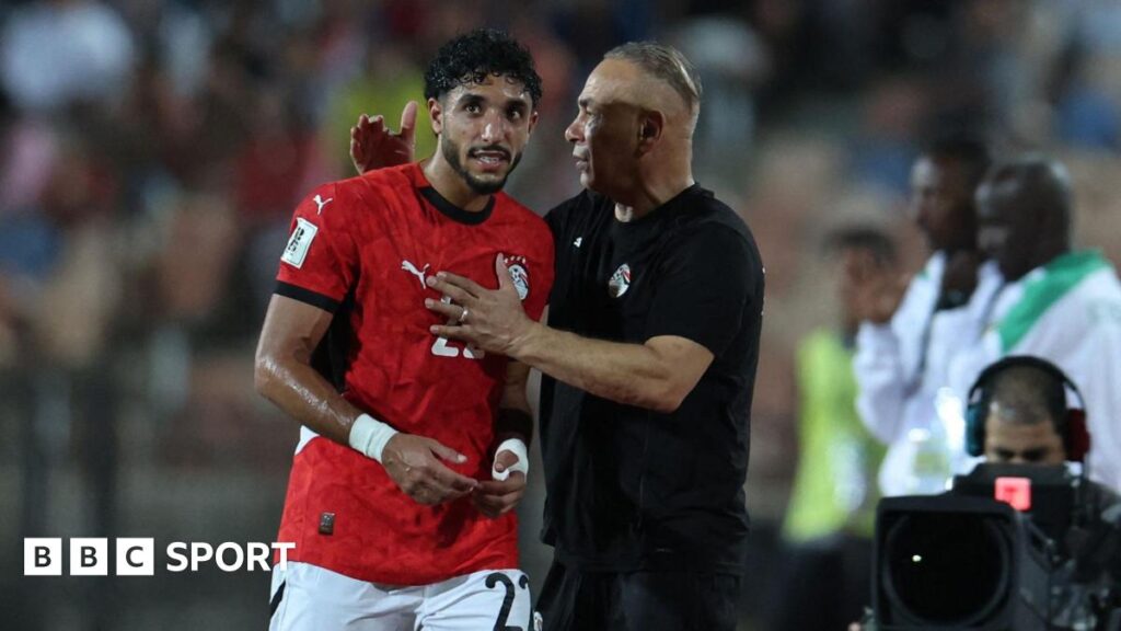 Omar Marmoush embraces Egypt head coach Hossam Hassan after being substituted