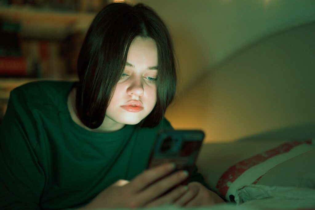 OpenAI to route sensitive conversations to GPT-5, introduce parental controls Portrait of a teenage girl looking at her mobile phone.